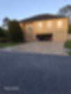 Two-story house with concrete driveway and yellow markings