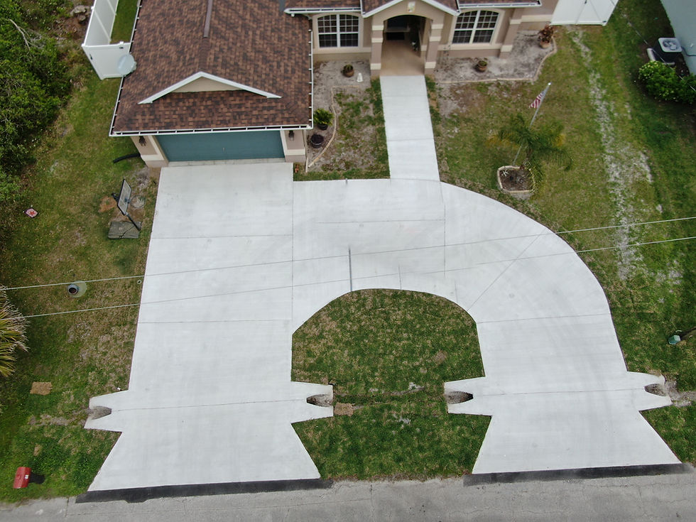 House with wide custom concrete driveway