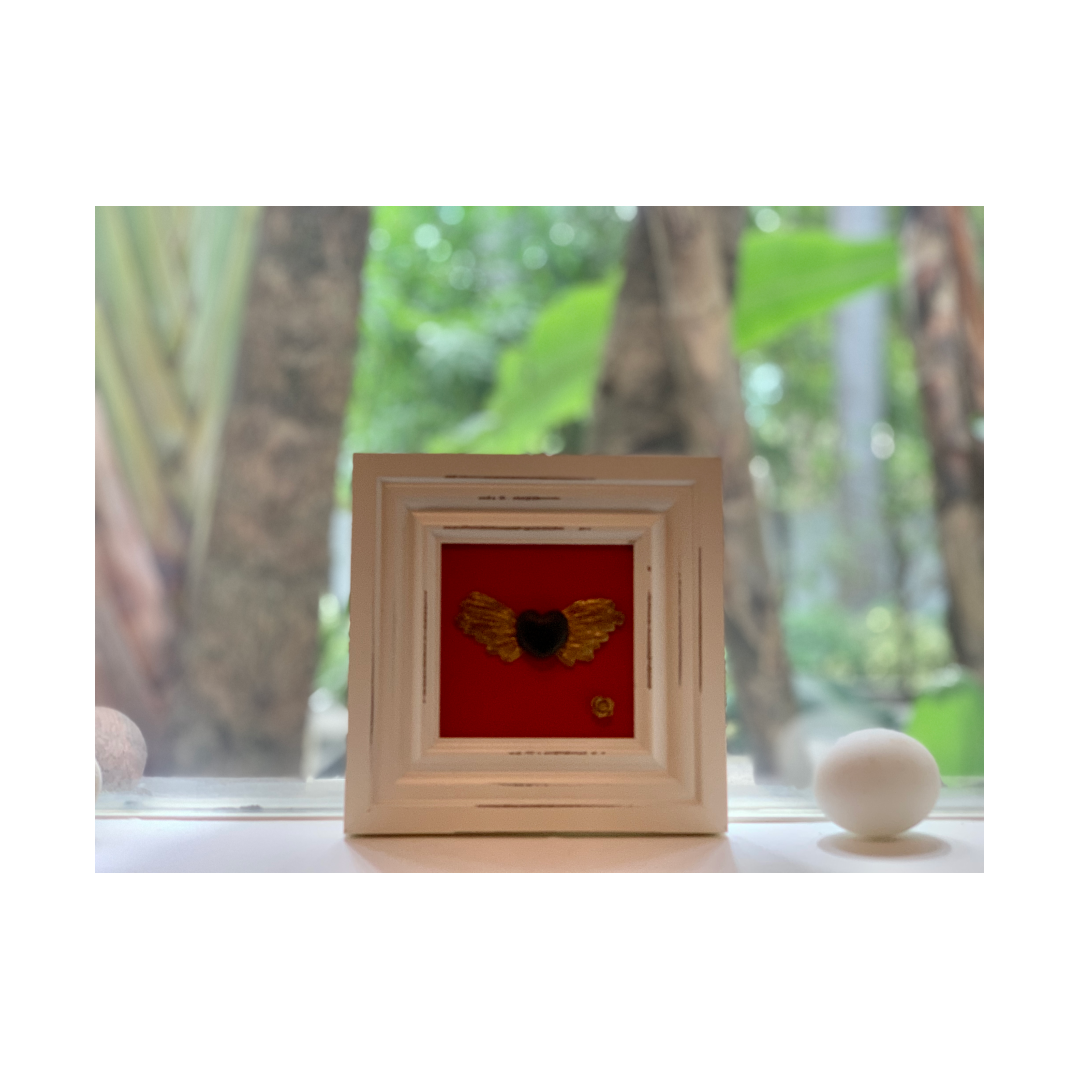 Black winged heart with golden rose