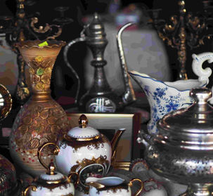 A collection of ornate antique ceramics and metalware, including a gilded vase