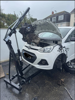 A white car with its hood open