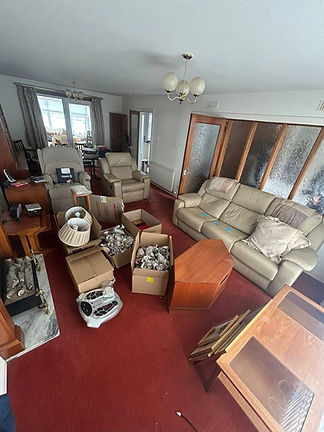A living room with sofas and armchairs on a red carpet