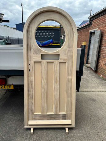 A curved wooden door.