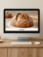 Site de padaria artesanal em monitor, exibindo presença online profissional.