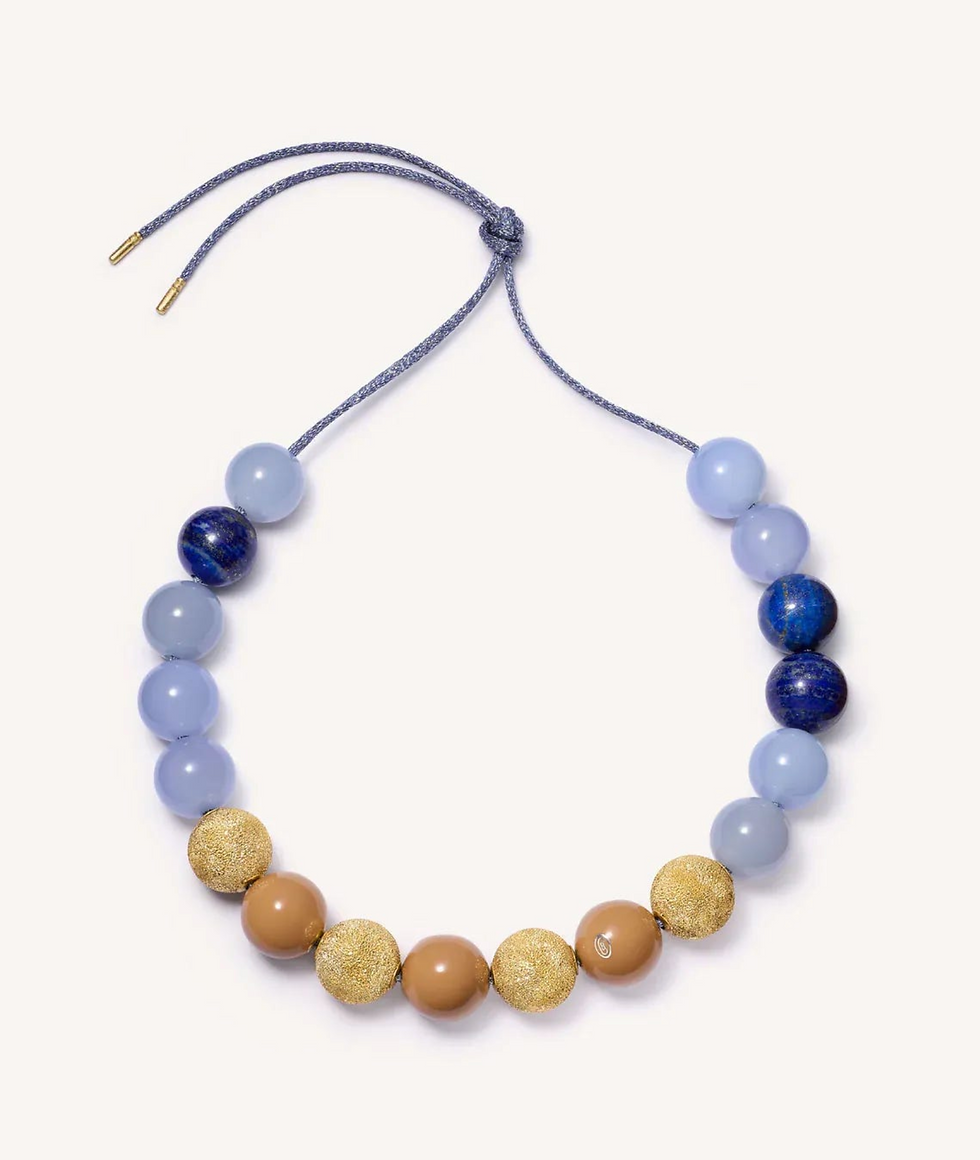 Greenwich Village Downtown necklace in lurex thread, 18k gold tips with chalcedony, lapis lazuli, enamel, and Florentine finish 18k yellow gold spheres, $13,290; Carolina Bucci