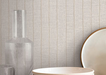 Cording Stripe wallpaper features vertical twisted trim on a woven canvas, creating a blend of classic and cottage styles in pearlescent and white