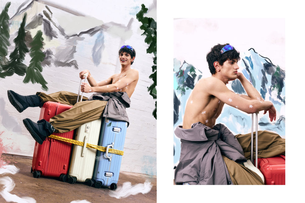 Male model posing with multi-colored suitcases for L'OFFICIEL MY