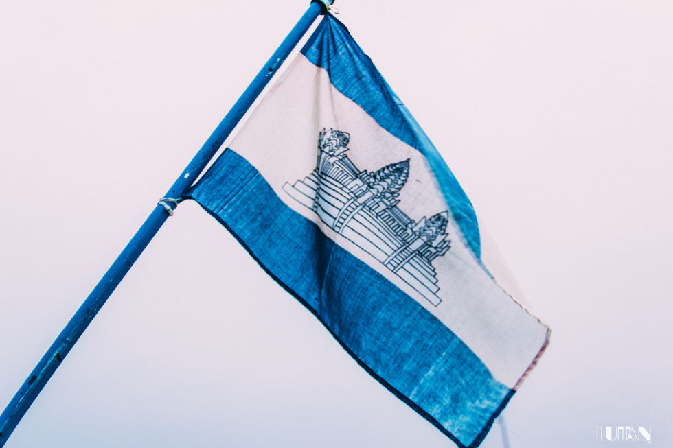 Cambodian national flag with Angkor Wat on a blue pole.