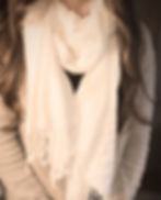 a woman wearing a scarf around her neck with a hidden face mask sewn into it