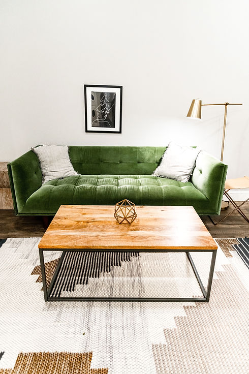 brown wooden table near green sofa_edited_edited.jpg