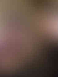 Selfie of Olivia and Tia at Shutterfest. Olivia is holding toasted ravioli and Tia is holding a ball python.