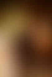 Boudoir photo of woman crawling on all fours. Golden and moon lighting.