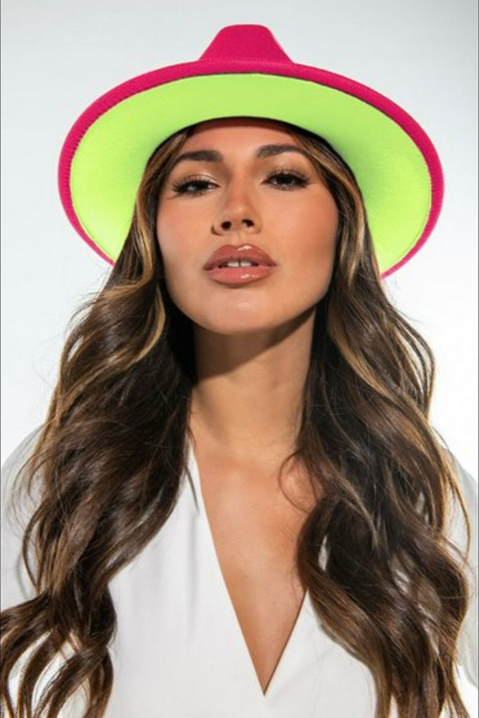 Woman wearing hat posing for a photo, with Madame Curves