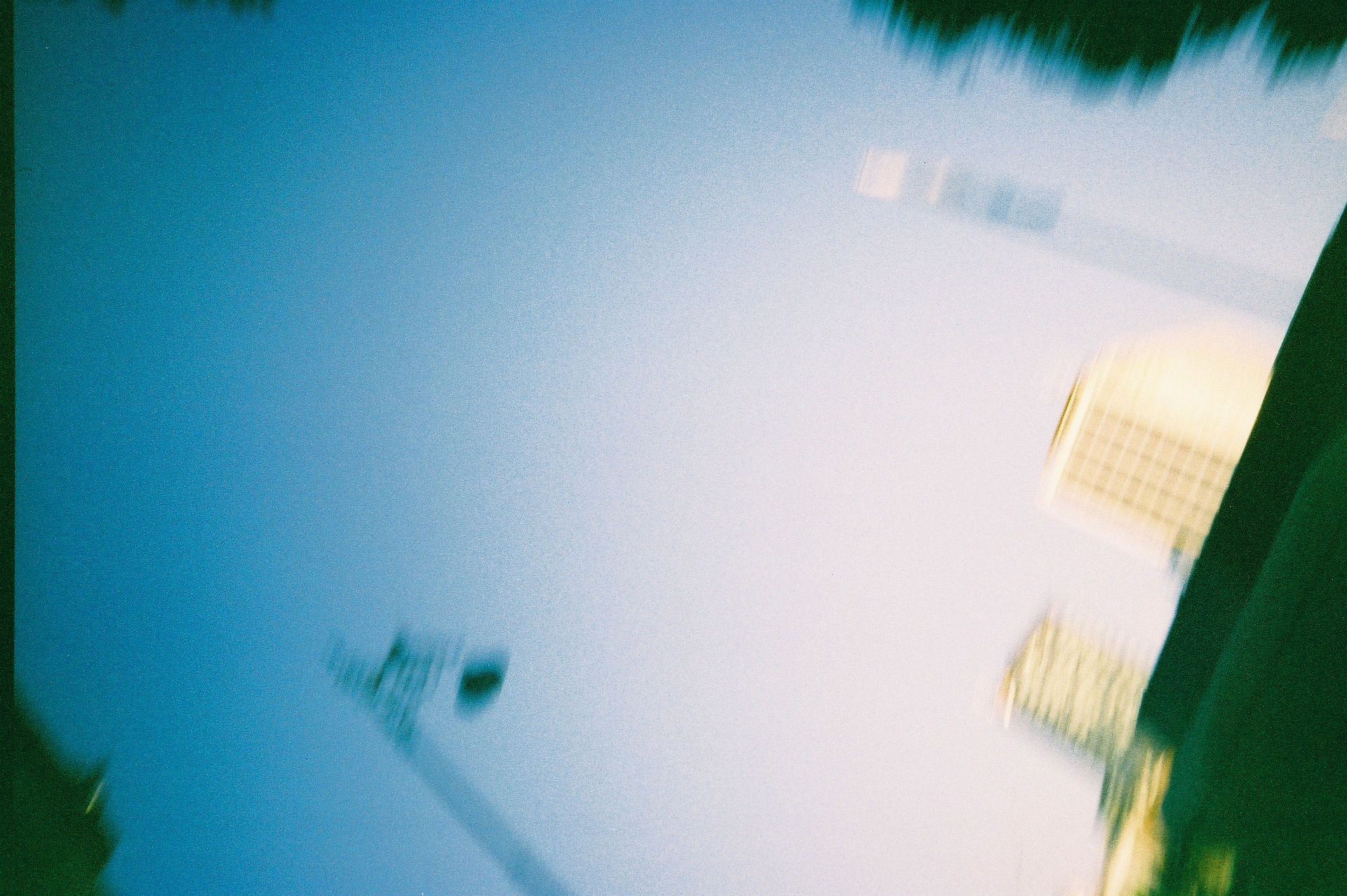 Blurry film photography of buildings against a Dublin sky