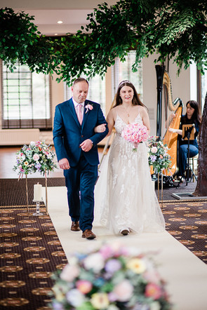 father of the bride walking the bride down the aisle