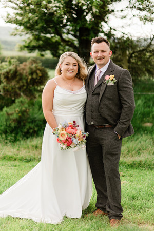 the newlyweds looking at the camera