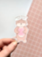 image of sticker of cute kawaii-style otter, holding a book named 'otter nonsense', with text 'otterly obsessed with books'