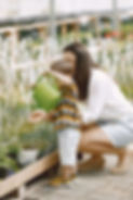 mom-her-son-with-green-watering-can-greenhouse-little-toddler-boy-watering-flowers-greenho