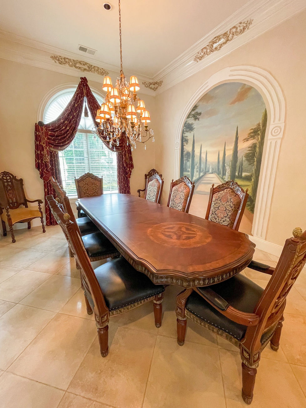 a dining room with a table and chairs and a chandelier