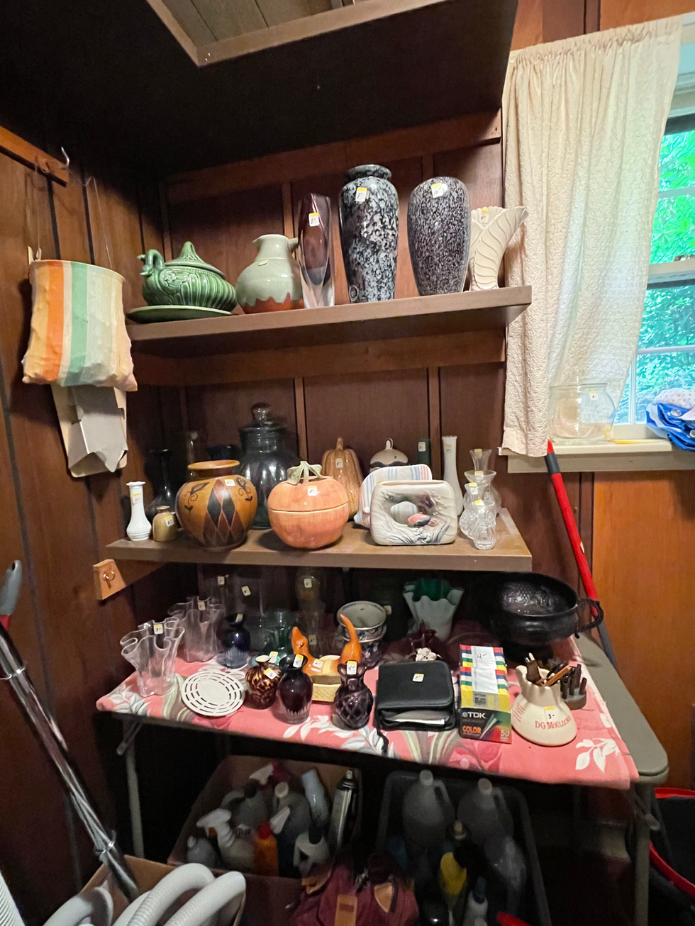 a shelf full of vases and a box of tdk gold