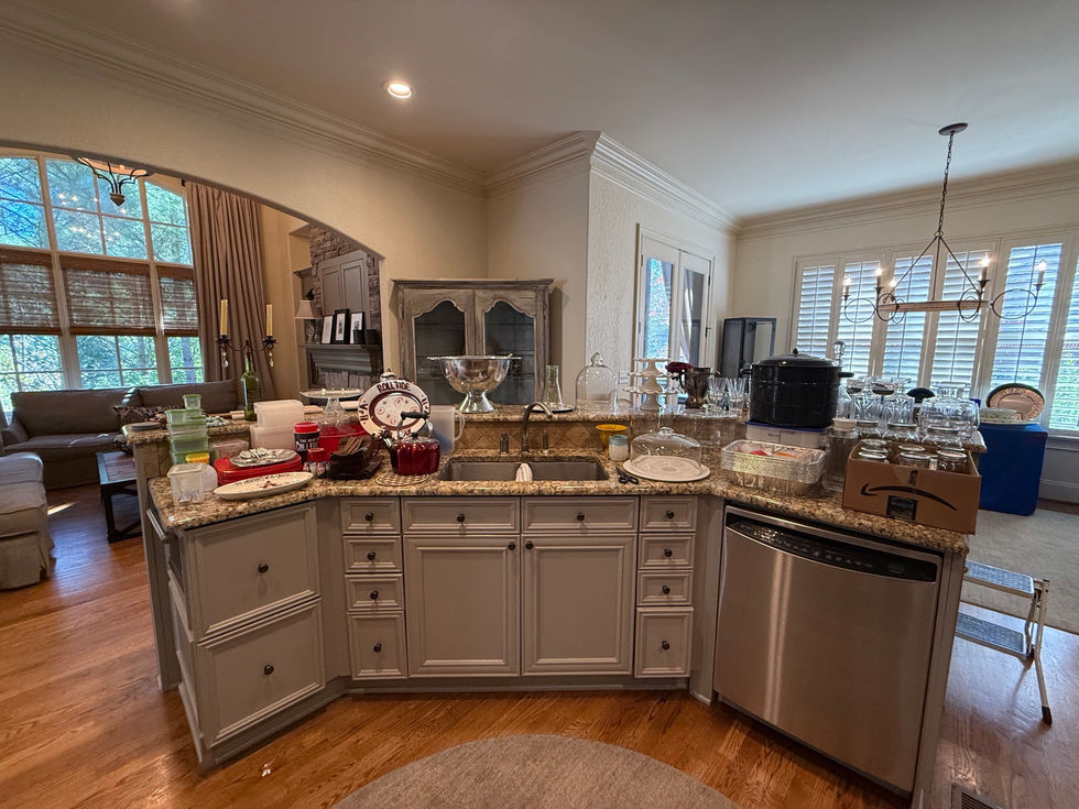 a kitchen with white cabinets and a stainless steel dishwasher