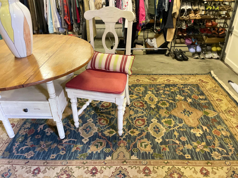 a chair with a red cushion sits on a rug