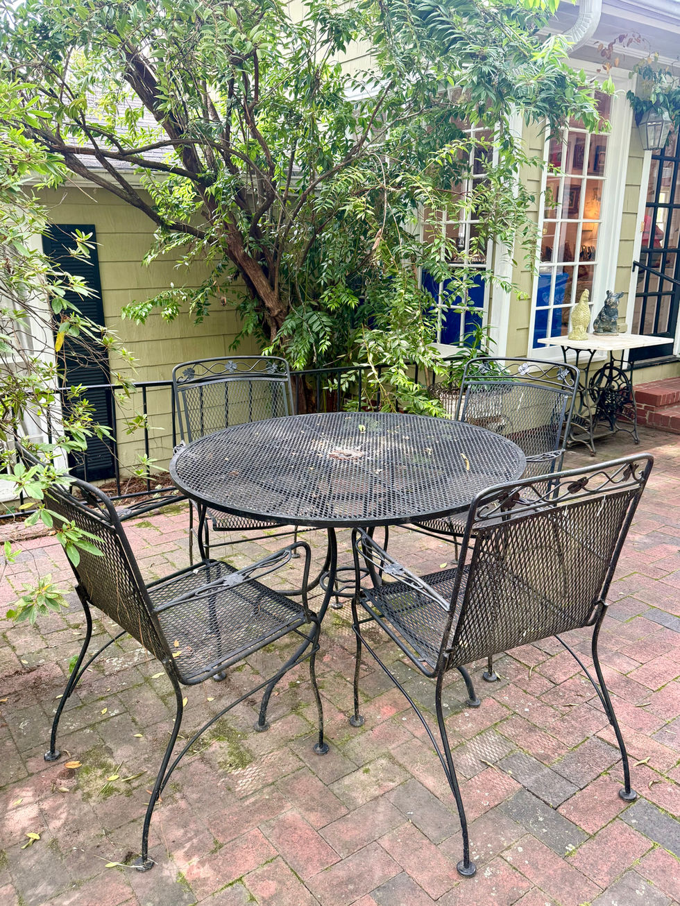 Outdoor patio with metal table and chairs.