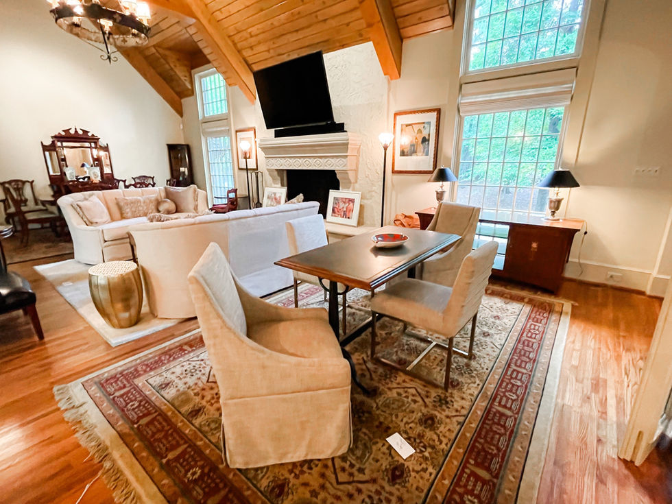 a living room with a table and chairs and a fireplace