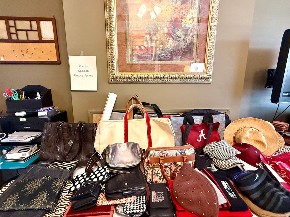 Table with various accessories and bags displayed.