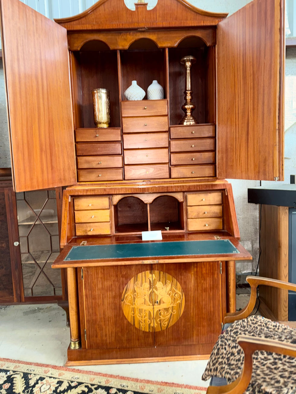 Wooden cabinet with drawers and decorative carvings.