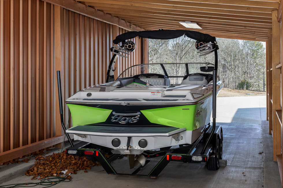a green and white boat with the letters gos on the back