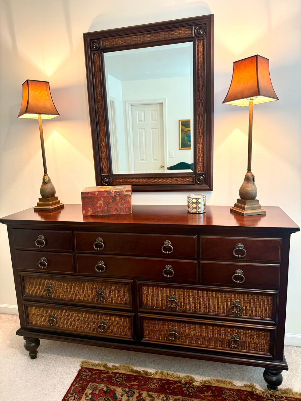 Wooden dresser with mirror and two lamps.