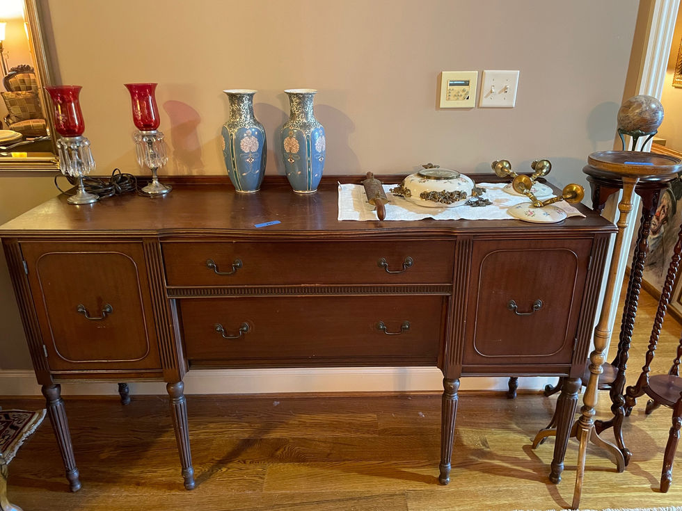 a wooden dresser with two vases on top of it