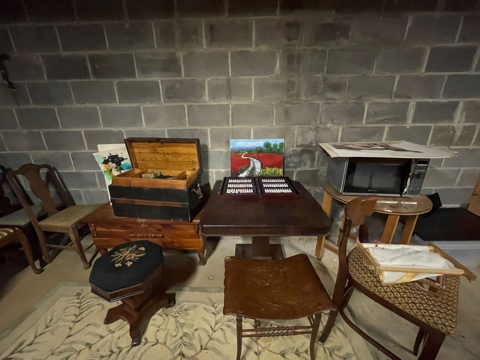 a table with a painting on the wall behind it