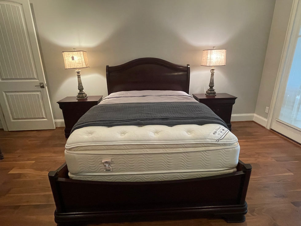 a bed with a mattress and two lamps on it