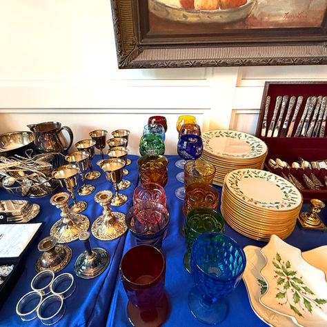 Table with glassware and hanging picture