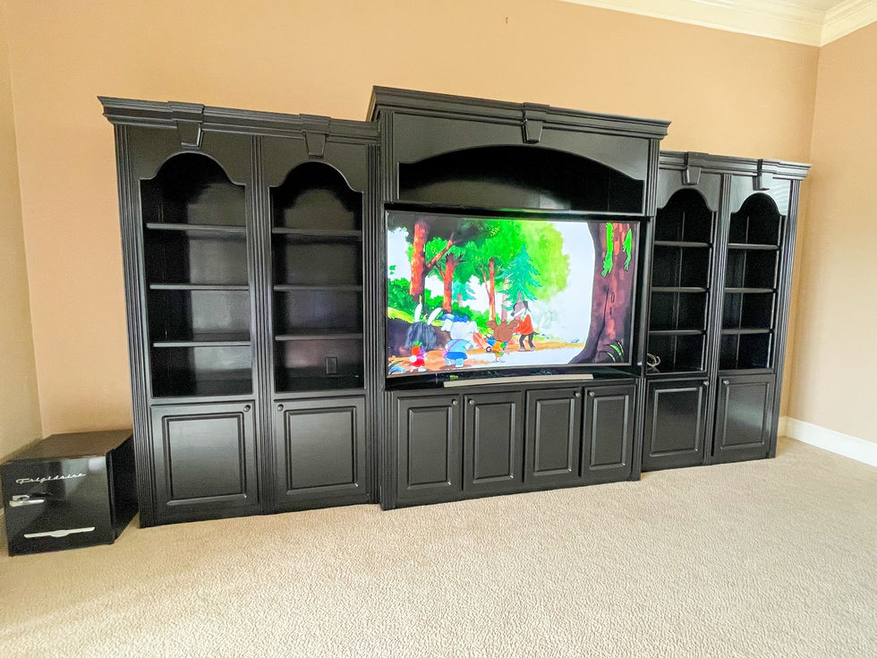 a large black entertainment center with a flat screen tv