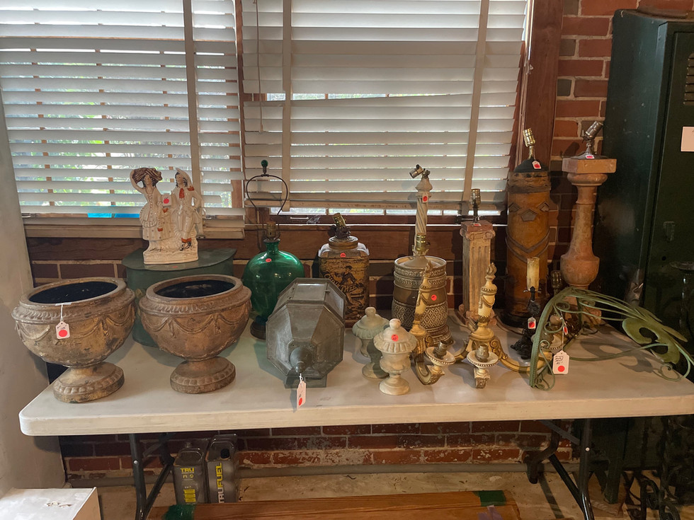 a table full of lamps and vases has a tag on it that says true lite