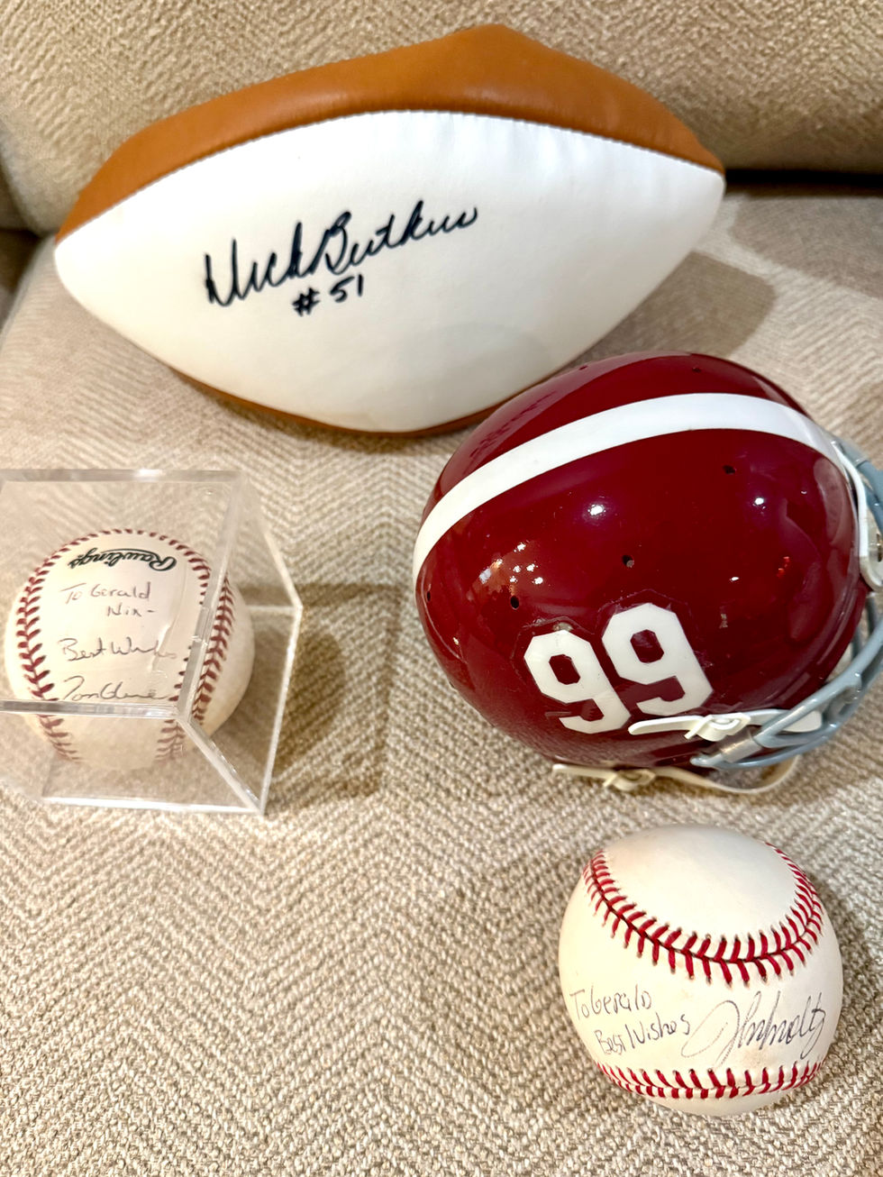 Signed football, helmet, and baseball memorabilia display.