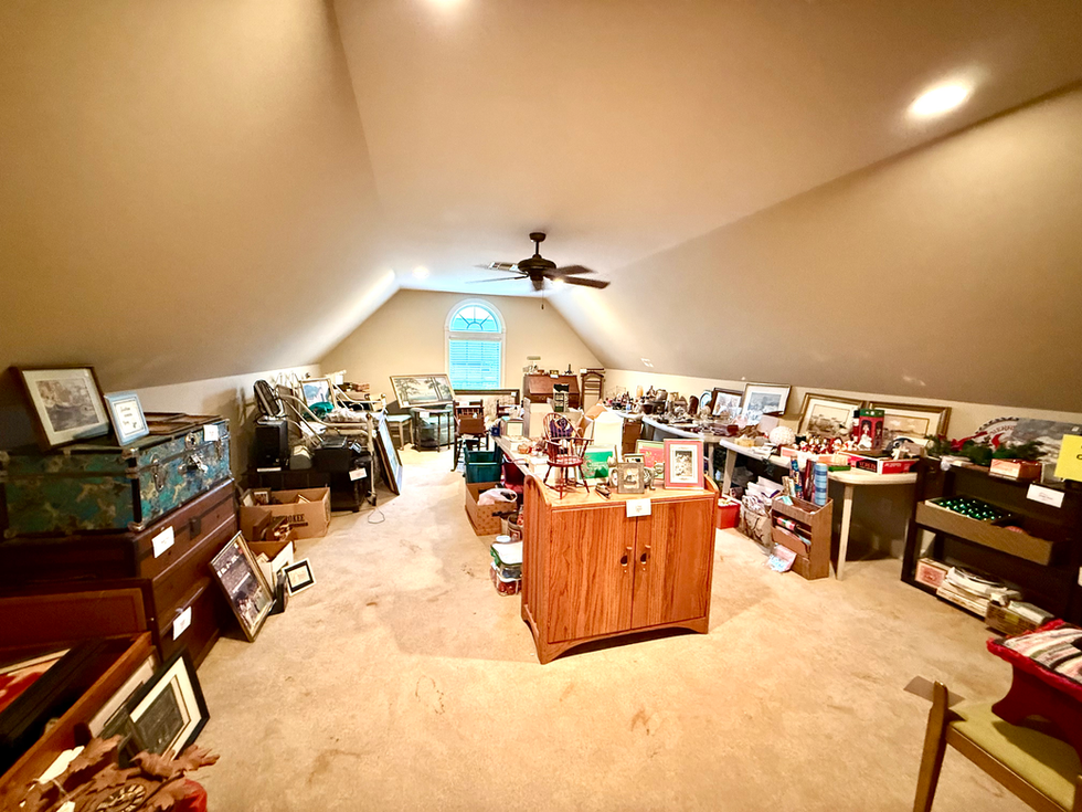 a cluttered room with a ceiling fan and a sign that says ' a ' on it
