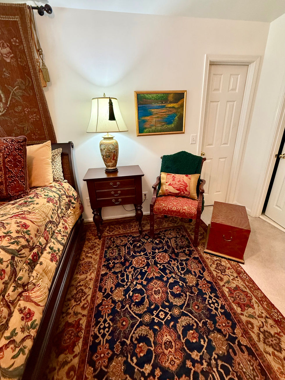 Cozy room with patterned rug and vintage furniture.