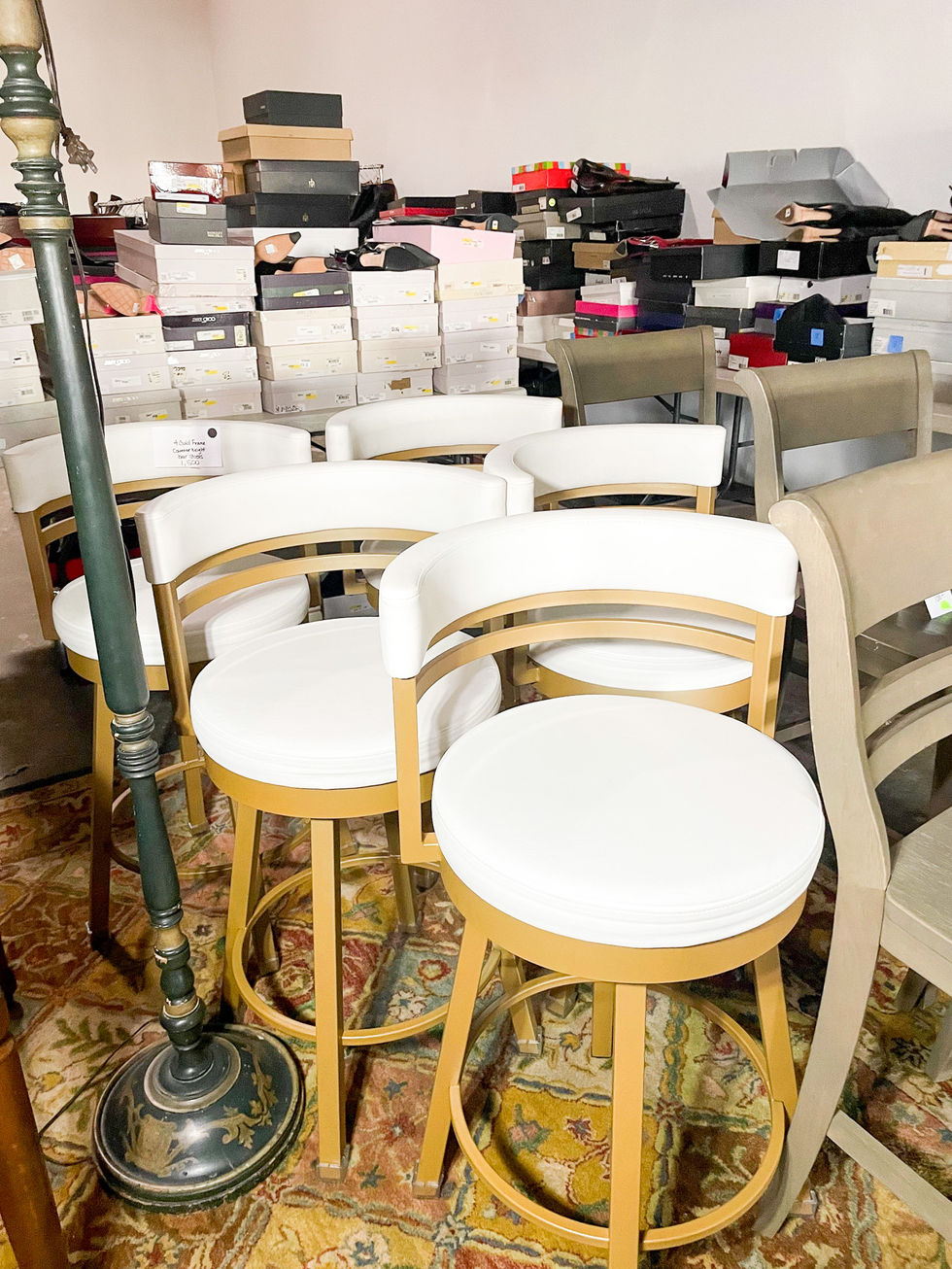 a bunch of chairs are sitting in a room with boxes of shoes on the floor