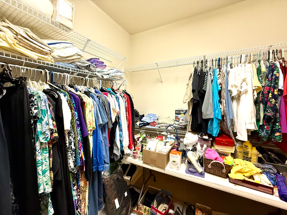 a closet filled with clothes and a box that says skill bag