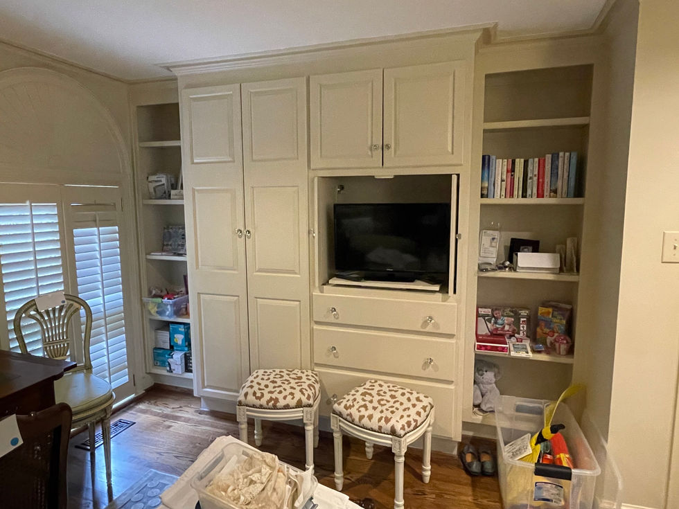 a living room filled with lots of books and a tv