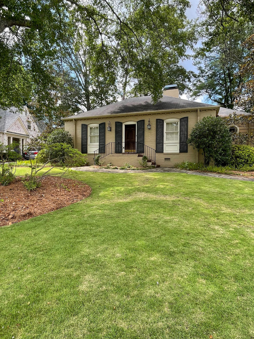 a house with a lush green lawn in front of it