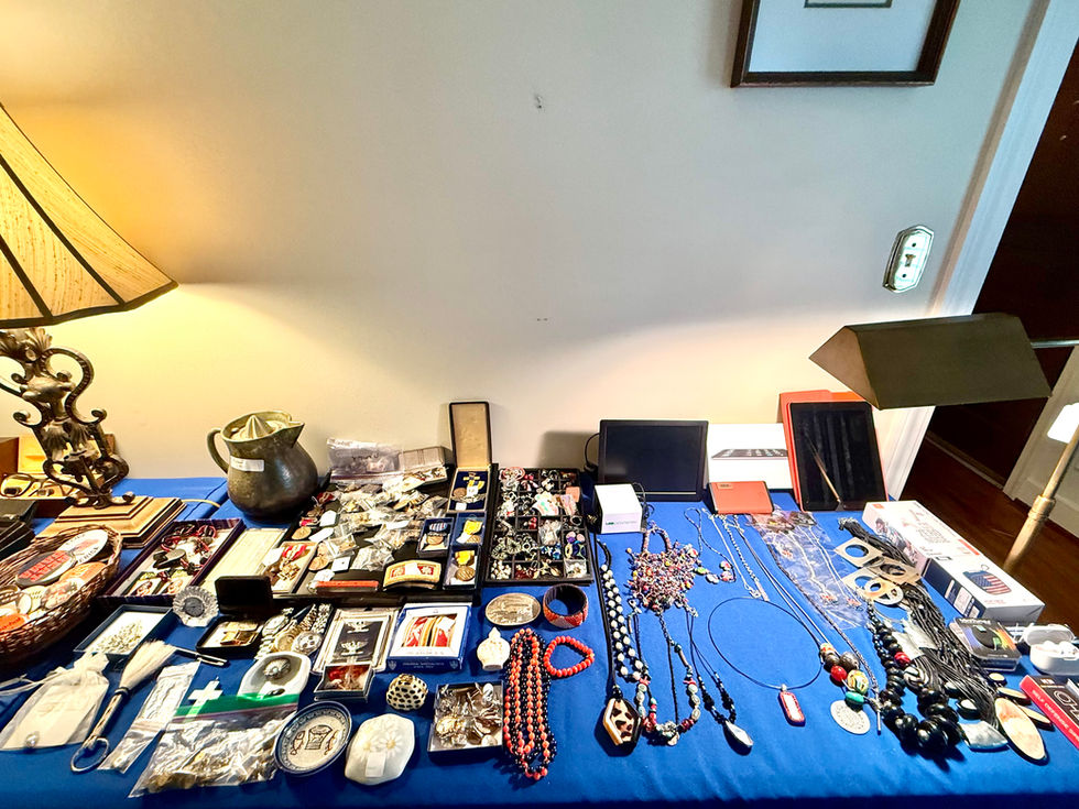 Table with various jewelry and trinkets displayed.