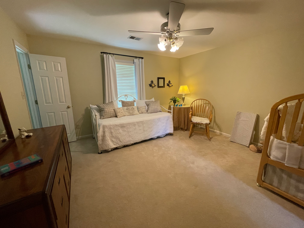a bedroom with a day bed and a ceiling fan