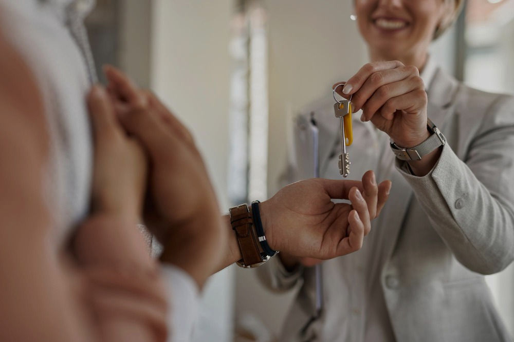 closeup-couple-receiving-keys-their-new-