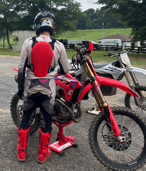 Back view of Alpinestars A-4 Plasma Chest Protector showing spine coverage – motocross armor on rider