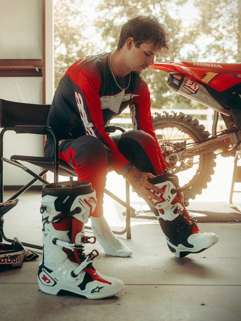 Jett Lawrence putting on Alpinestars MX27 motocross gear and Tech 10 mx boots before riding.